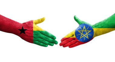 Etiyopya ve Gine Bissau bayrakları arasındaki el sıkışma ellerinde resmedilmiş şeffaf görüntü.
