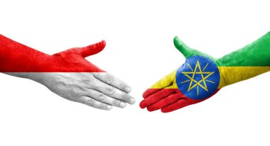 Etiyopya ve Endonezya bayrakları arasındaki el sıkışma ellerinde izole şeffaf görüntü.