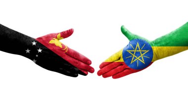 Etiyopya ve Papua Yeni Gine bayrakları arasındaki tokalaşma elleri boyalı, izole şeffaf görüntü.