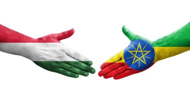 Etiyopya ve Macaristan bayrakları arasındaki el sıkışma ellerinde izole şeffaf görüntü.