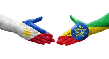 Etiyopya ve Filipinler arasındaki el sıkışma ellerinde boyanmış bayraklar, izole şeffaf görüntü.