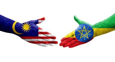 Etiyopya ve Malezya bayrakları arasında el sıkışma ellerinde izole şeffaf görüntü.