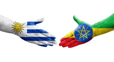 Etiyopya ve Uruguay bayrakları arasındaki el sıkışma ellerinde izole şeffaf görüntü.