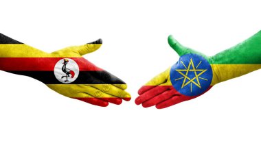 Etiyopya ve Uganda bayrakları arasındaki el sıkışma ellerinde izole şeffaf görüntü.