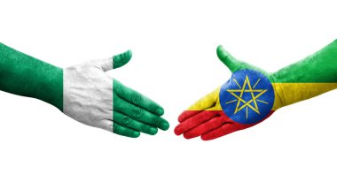 Etiyopya ve Nijerya bayrakları arasındaki el sıkışma ellerinde izole şeffaf görüntü.