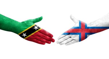 Faroe Adaları ile Saint Kitts ve Nevis bayrakları arasındaki el sıkışma..