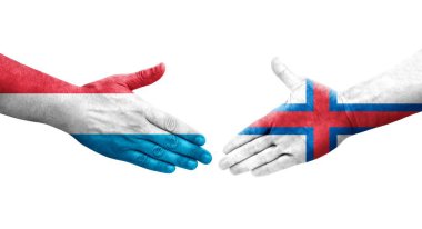 Faroe Adaları ve Lüksemburg bayrakları arasındaki el sıkışma, izole şeffaf görüntü.