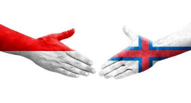 Faroe Adaları ile Endonezya bayrakları arasındaki el sıkışma, izole şeffaf görüntü.