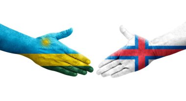 Faroe Adaları ve Ruanda bayrakları arasındaki el sıkışma ellerinde izole şeffaf görüntü.