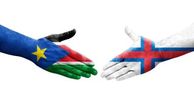 Faroe Adaları ile Güney Sudan bayrakları arasındaki el sıkışma, izole şeffaf görüntü.