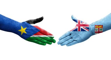 Fiji ve Güney Sudan bayrakları arasında el sıkışma, izole şeffaf görüntü.