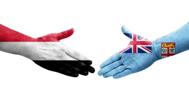 Fiji ve Yemen bayrakları arasındaki el sıkışma ellerinde resmedilmiş şeffaf bir görüntü.