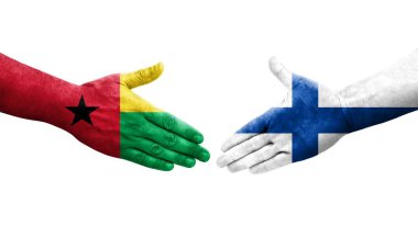 Finlandiya ile Gine Bissau bayrakları arasındaki el sıkışma ellere boyanmış, izole şeffaf görüntü.