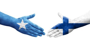 Finlandiya ile Somali bayrakları arasındaki el sıkışma ellerde resmedilmiş, izole edilmiş şeffaf görüntü.