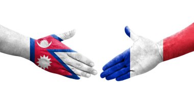 Fransa ve Nepal bayrakları arasındaki el sıkışma ellerinde resmedilmiş şeffaf bir görüntü.
