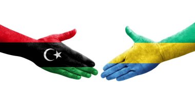 Gabon ve Libya bayrakları arasındaki el sıkışma el yazısı, izole şeffaf görüntü.