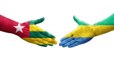 Gabon ve Togo bayrakları arasındaki tokalaşma elleri boyalı, izole şeffaf görüntü.