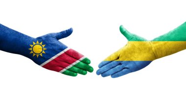 Gabon ve Namibya bayrakları arasındaki el sıkışma ellerinde izole şeffaf görüntü.
