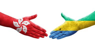 Gabon ve Hong Kong bayrakları arasındaki el sıkışma ellerinde resmedilmiş şeffaf bir görüntü..