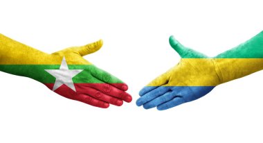Gabon ve Myanmar bayrakları arasındaki el sıkışma ellerinde izole şeffaf görüntü.