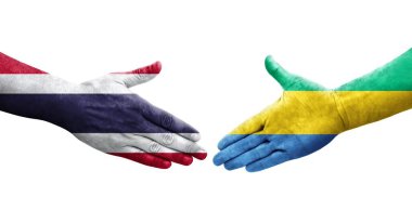 Gabon ve Tayland bayrakları arasındaki el sıkışma ellerinde izole şeffaf görüntü.