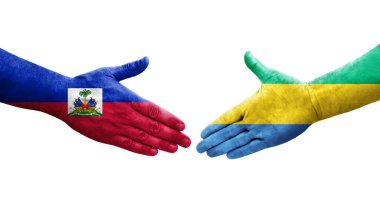 Gabon ve Haiti bayrakları arasındaki tokalaşma ellerinde izole şeffaf görüntü.