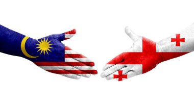 Ellerinde Gürcistan ve Malezya bayrakları arasında el sıkışma, izole şeffaf görüntü.