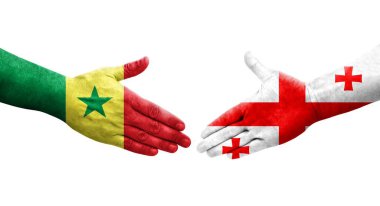 Ellerinde Gürcistan ve Senegal bayrakları arasında el sıkışma, izole şeffaf görüntü.
