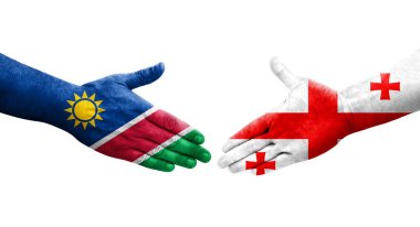 Ellerinde Gürcistan ve Namibya bayrakları arasında el sıkışma, izole şeffaf görüntü.