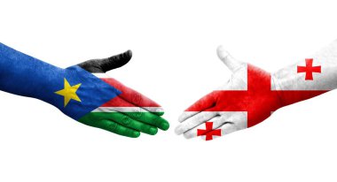 Gürcistan ve Güney Sudan bayrakları arasındaki el sıkışma ellerinde şeffaf bir görüntü..