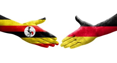 Almanya ile Uganda bayrakları arasındaki el sıkışma, izole şeffaf görüntü.