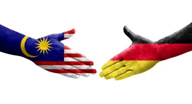 Almanya ile Malezya bayrakları arasındaki el sıkışma, izole şeffaf görüntü.