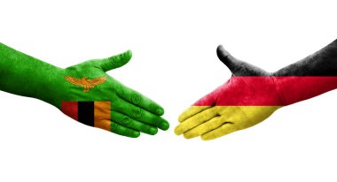 Almanya ile Zambiya bayrakları arasındaki el sıkışma, izole saydam görüntü.