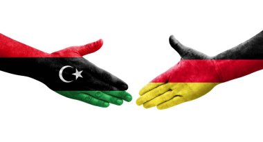Almanya ile Libya bayrakları arasındaki el sıkışma, izole edilmiş şeffaf görüntü.