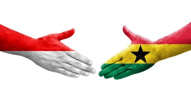Gana ve Endonezya bayrakları arasındaki el sıkışma ellerinde izole şeffaf görüntü.