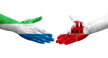 Gana ve Sierra Leone bayrakları arasındaki el sıkışma ellerinde izole şeffaf görüntü.