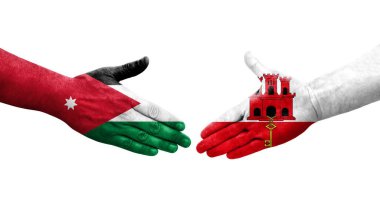 Cebelitarık ve Ürdün bayrakları arasındaki el sıkışma ellerinde izole şeffaf görüntü.