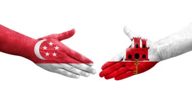 Cebelitarık ve Singapur bayrakları arasındaki tokalaşma ellerinde izole şeffaf görüntü.