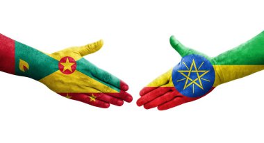 Grenada ve Etiyopya bayrakları arasındaki el sıkışma ellerinde izole şeffaf görüntü.