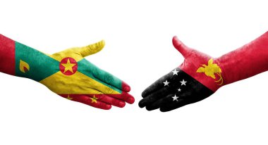 Grenada ve Papua Yeni Gine bayrakları arasındaki el sıkışma, izole şeffaf görüntü.