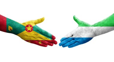 Grenada ve Sierra Leone bayrakları arasındaki el sıkışma ellerinde izole şeffaf görüntü.