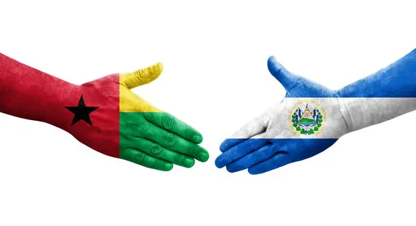 stock image Handshake between El Salvador and Guinea Bissau flags painted on hands, isolated transparent image.