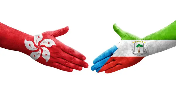 stock image Handshake between Equatorial Guinea and Hong Kong flags painted on hands, isolated transparent image.