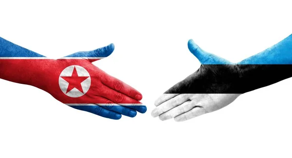 Händedruck Zwischen Estnischen Und Nordkoreanischen Flaggen Auf Hände Gemalt Isoliertes — Stockfoto