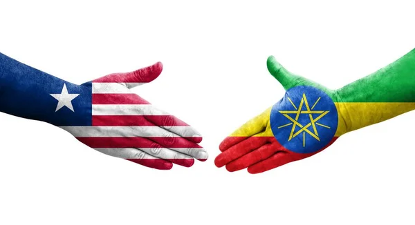 Händedruck Zwischen Äthiopien Und Liberia Flaggen Auf Hände Gemalt Isoliertes — Stockfoto
