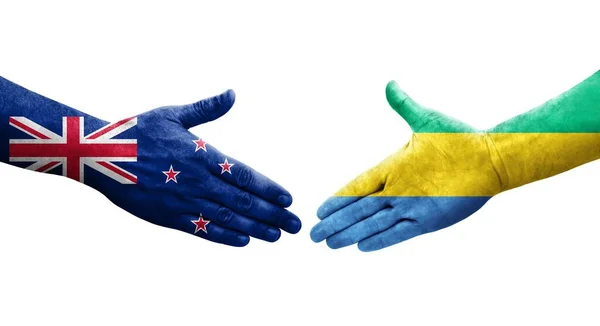 Apretón Manos Entre Gabón Nueva Zelanda Banderas Pintadas Las Manos — Foto de Stock