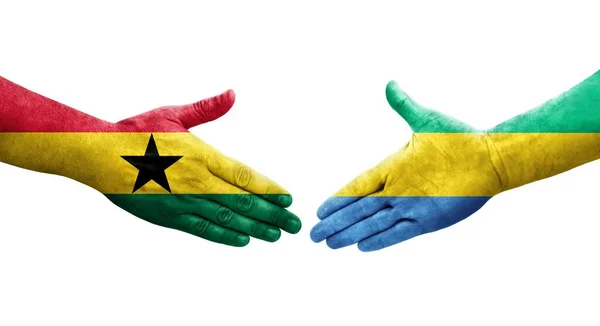 stock image Handshake between Gabon and Ghana flags painted on hands, isolated transparent image.