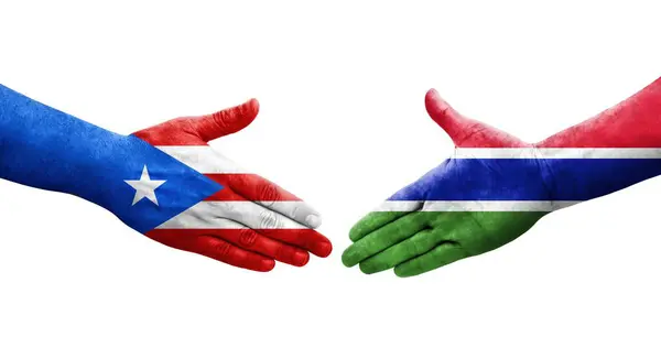 stock image Handshake between Gambia and Puerto Rico flags painted on hands, isolated transparent image.