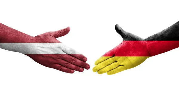 Apretón Manos Entre Alemania Letonia Banderas Pintadas Las Manos Imagen —  Fotos de Stock