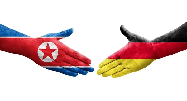 Handslag Mellan Tyskland Och Nordkorea Flaggor Målade Händer Isolerad Transparent — Stockfoto